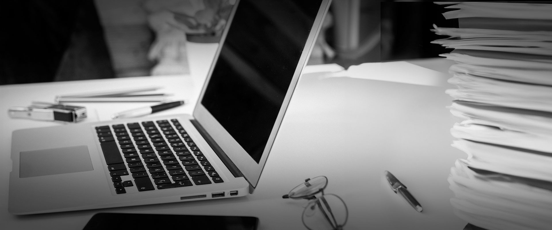 A Desktop with a Laptop Computer and a Stack of File Folders